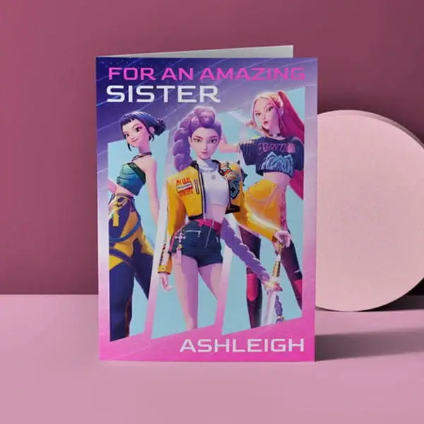 Personalised sister birthday card featuring animated character artwork and vibrant pink and purple design on a pastel background.
